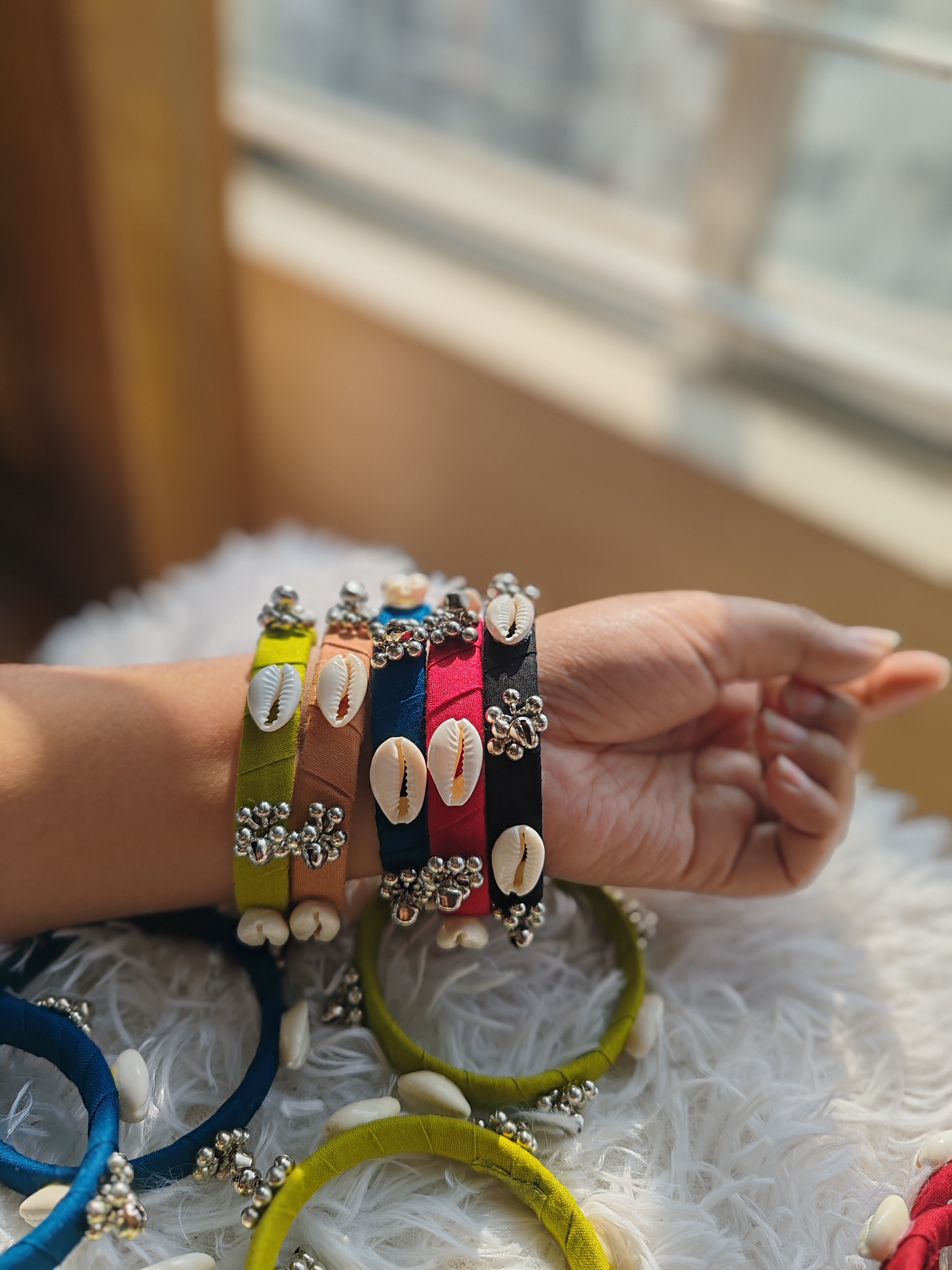 Multicolor cowrie shell bangles with silver accents
